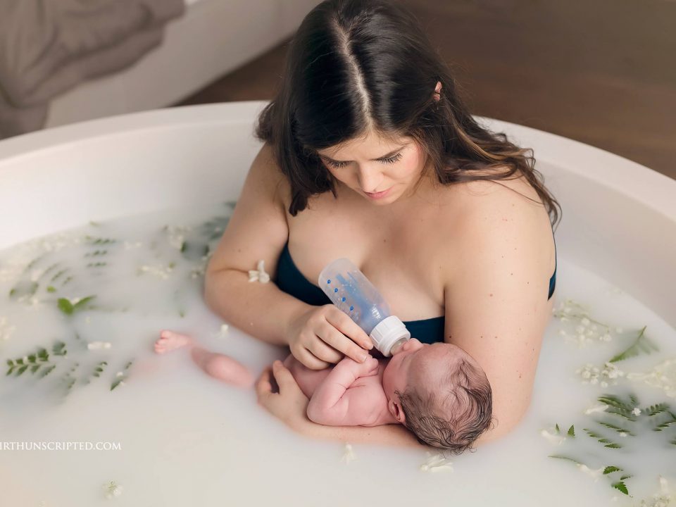 new mother bottle feeding newborn in a milk bath